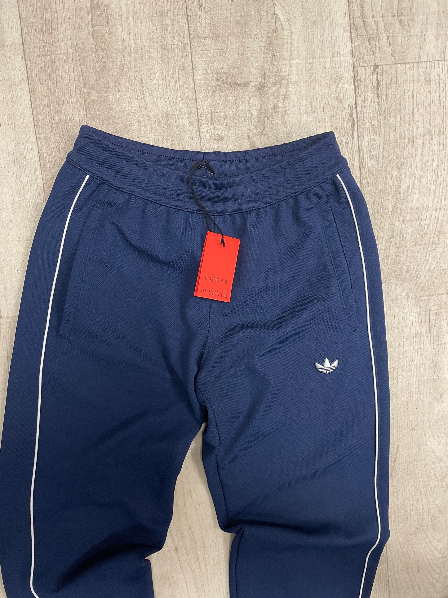 Navy blue Adidas joggers with white stripe