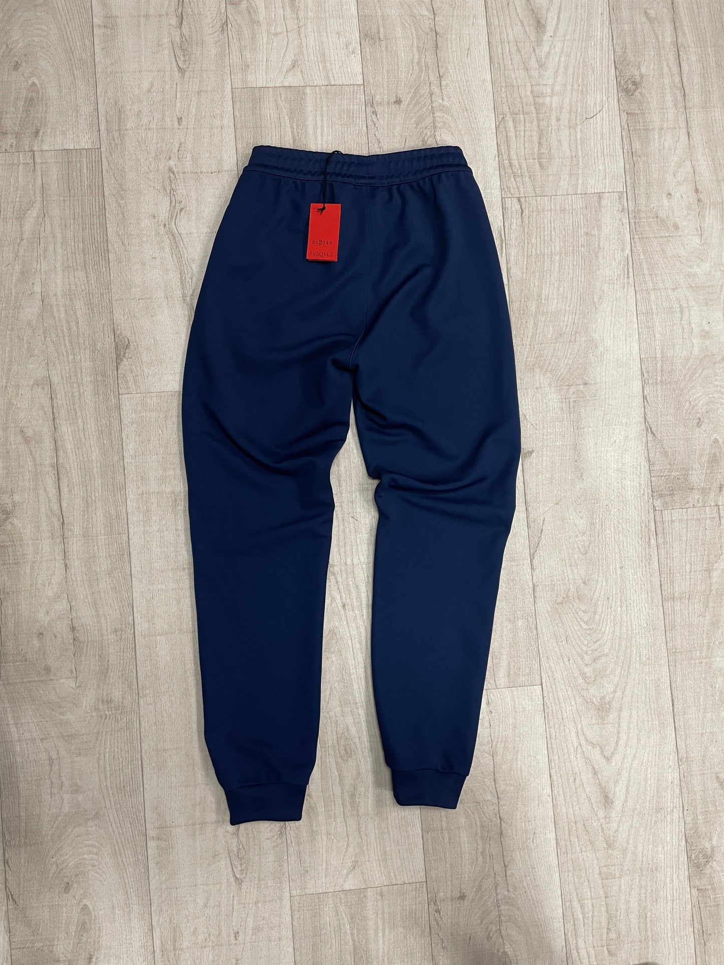 Navy blue Adidas joggers with white stripe