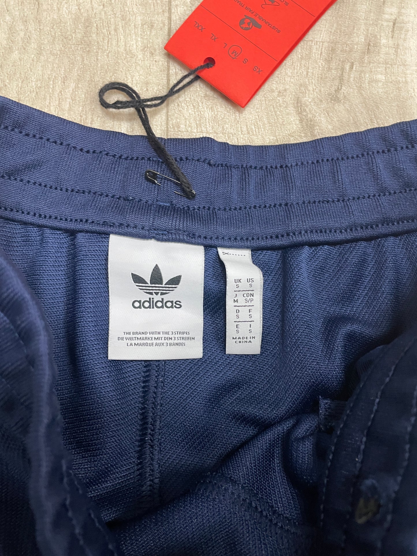 Navy blue Adidas joggers with white stripe