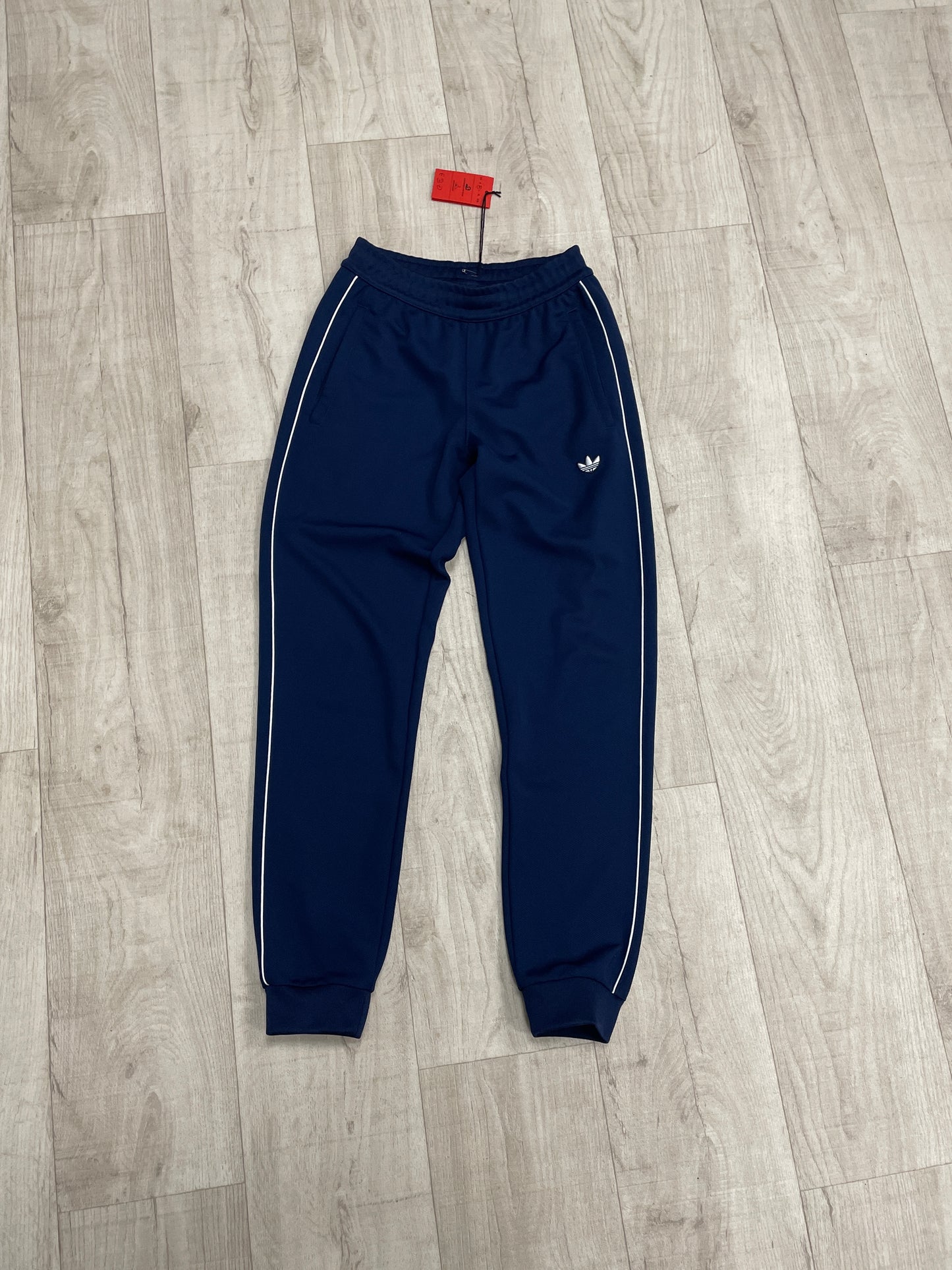 Navy blue Adidas joggers with white stripe