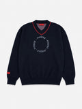 Black sweater with red accents and branding on a light gray background